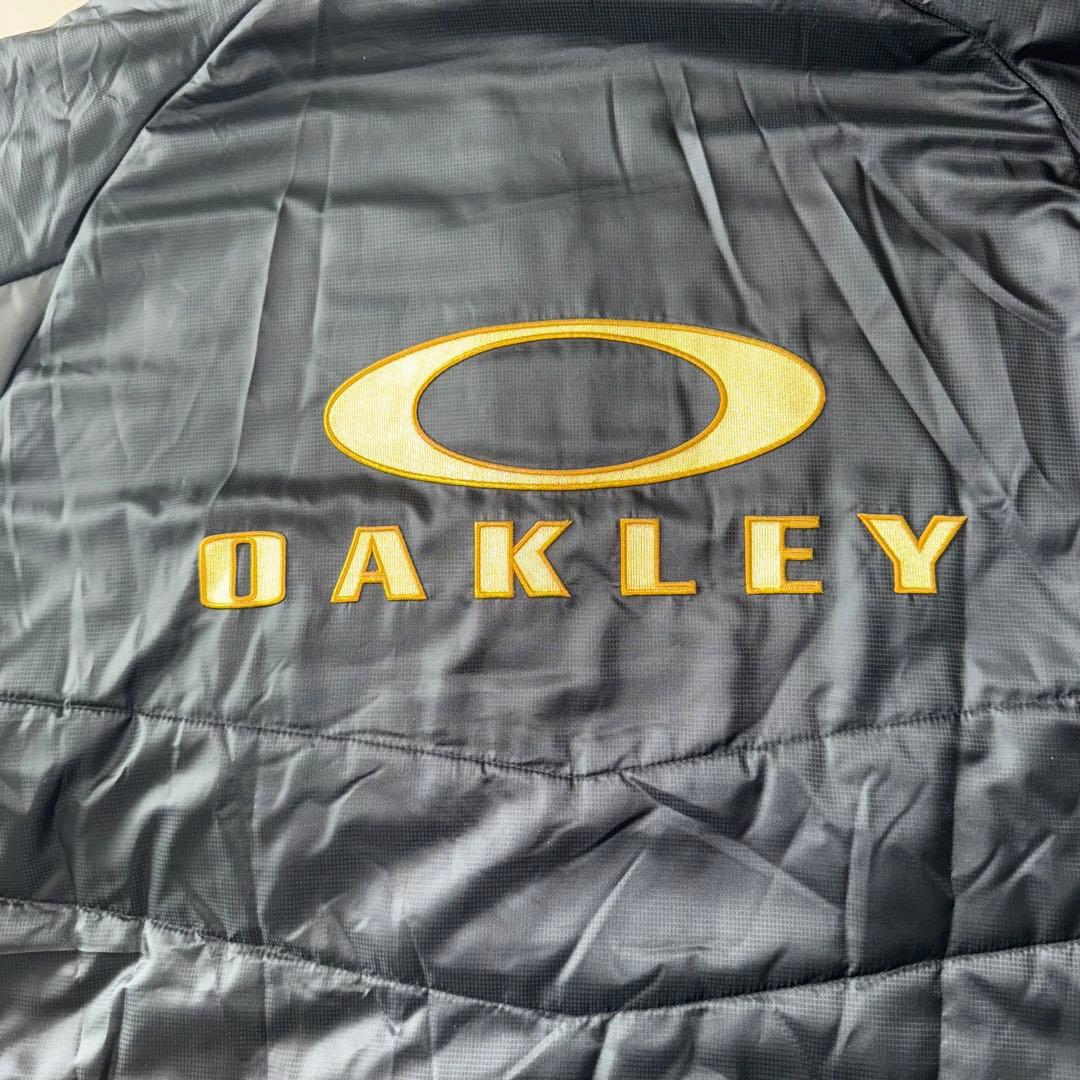 最終値下げ　美品　OAKLEY ベンチコート背面刺繍ビッグサイズ　バッグロゴ　金